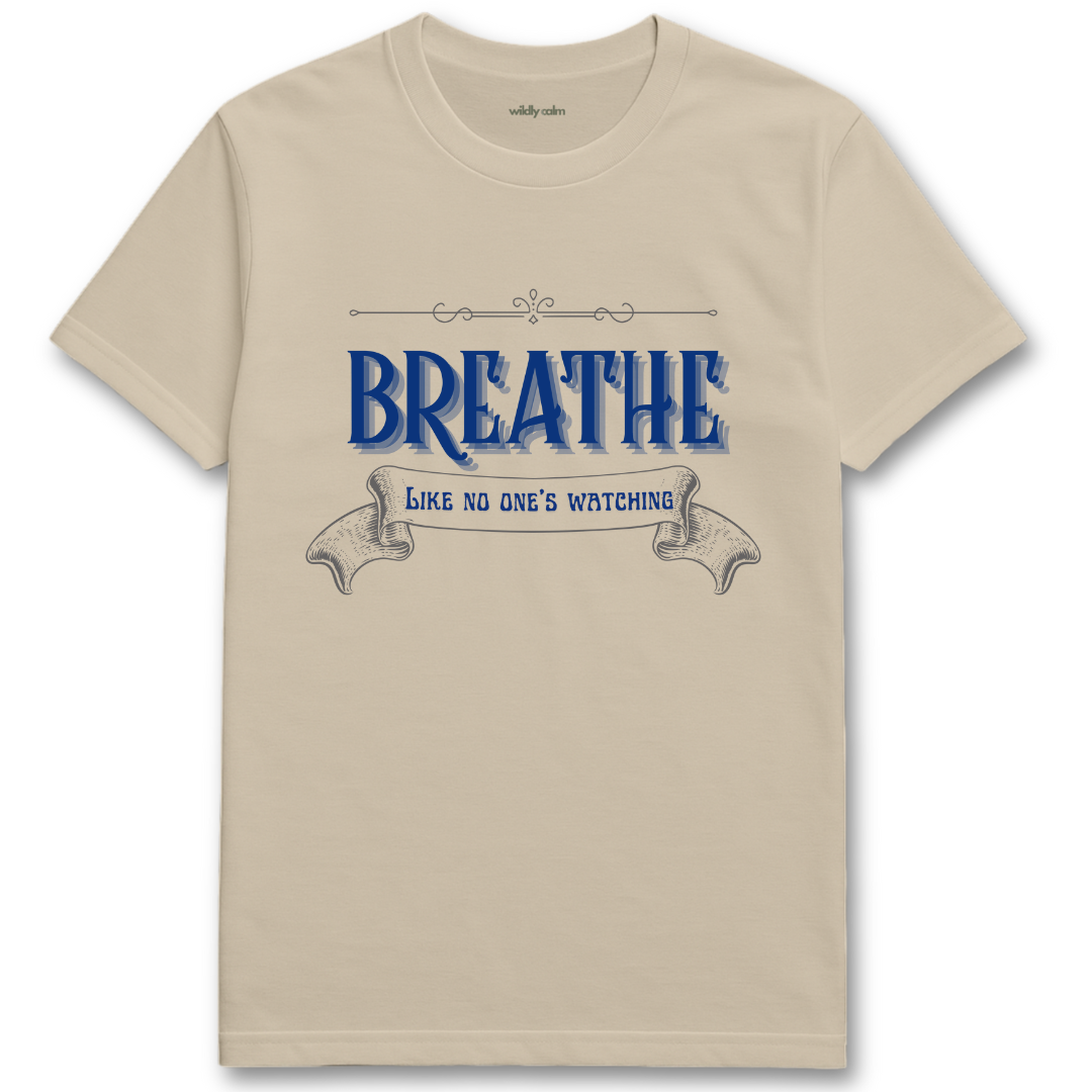 sand/ beige yoga t-shirt with blue text 'Breathe Like No One's Watching' -wildly calm