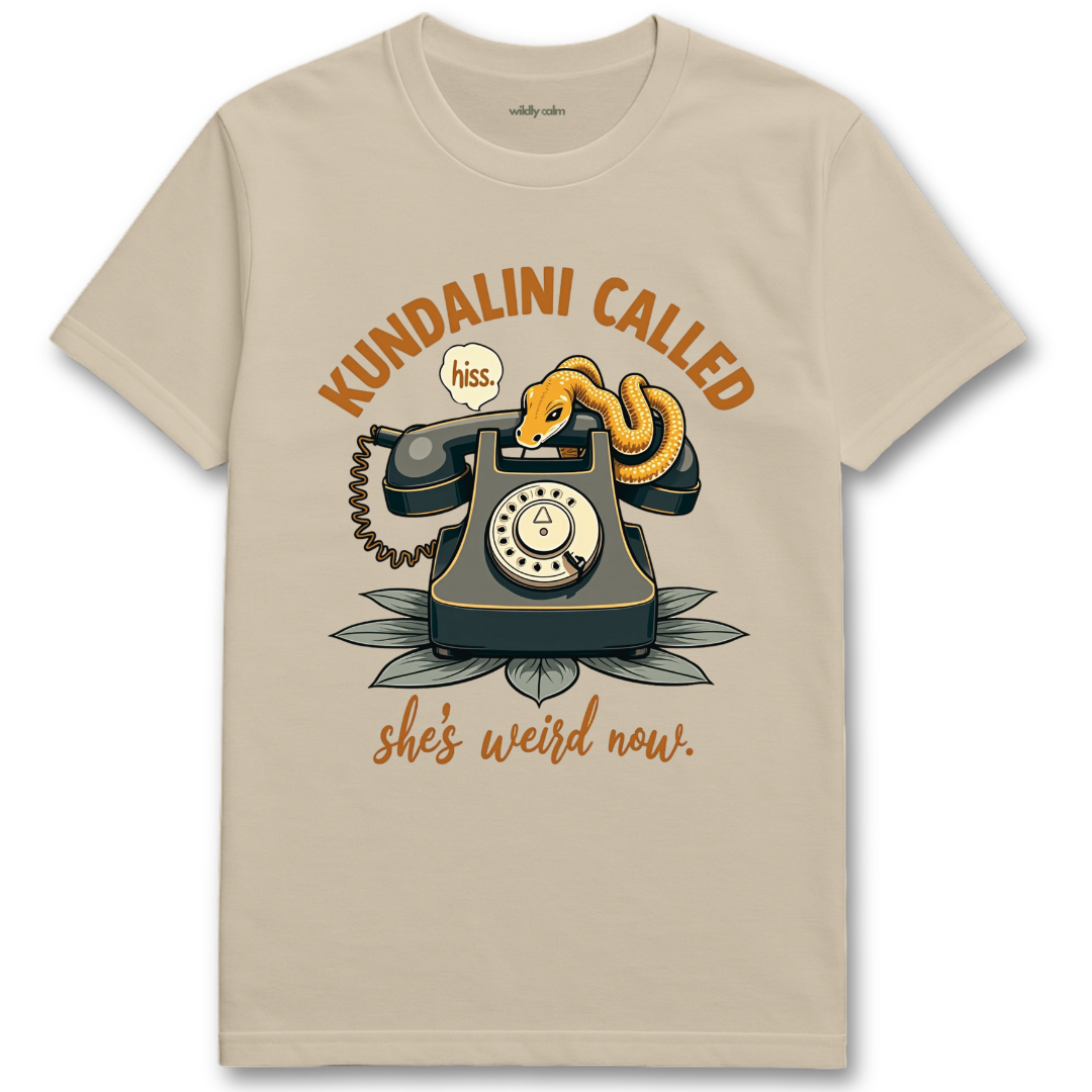 Sand/ Beige yoga t-shirt with a graphic of a phone and snake, text 'Kundalini Called she's weird now'- Wildly Calm