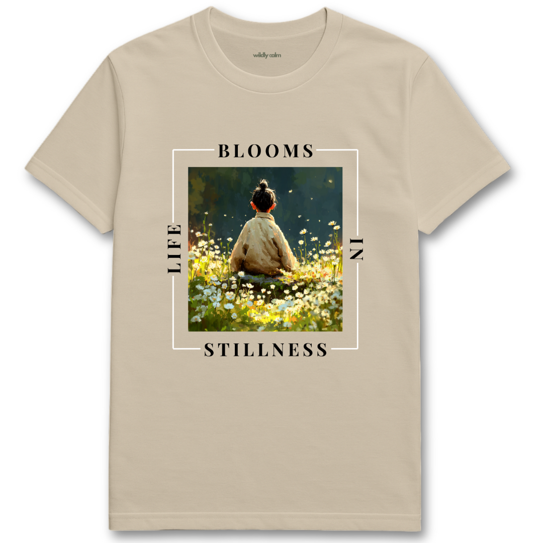 Life Blooms In Stillness sand yoga t-shirt with a graphic of a person sitting in a field and text 'BLOOMS LIFE STILLNESS' - wildly calm