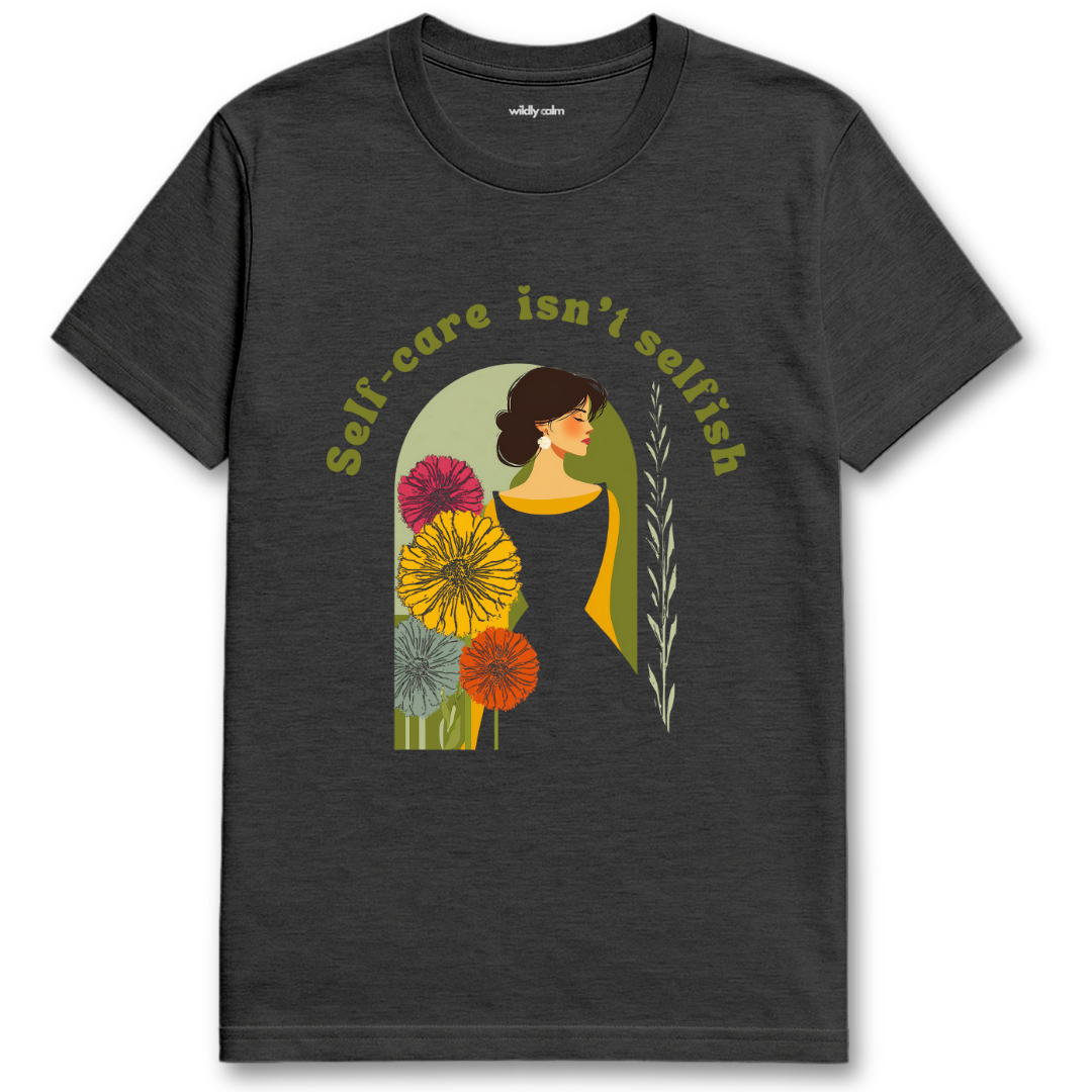 Self Care Isn't Selfish heather dark grey yoga t-shirt with a graphic of a woman surrounded by flowers and the text 'Self-care isn't selfish'. - wildly calm