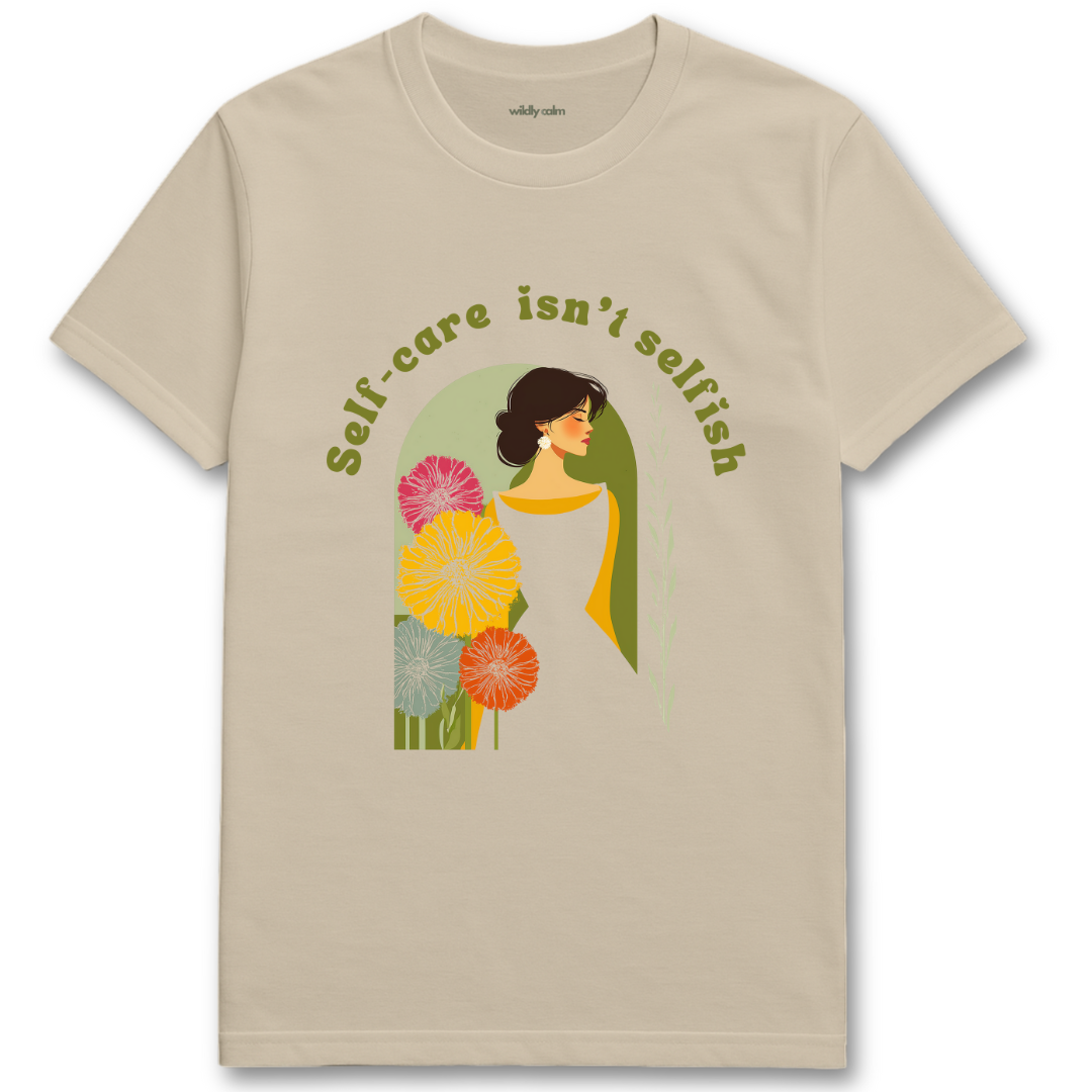Self Care Isn't Selfish sand yoga t-shirt with a graphic of a woman surrounded by flowers and the text 'Self-care isn't selfish'. - wildly calm