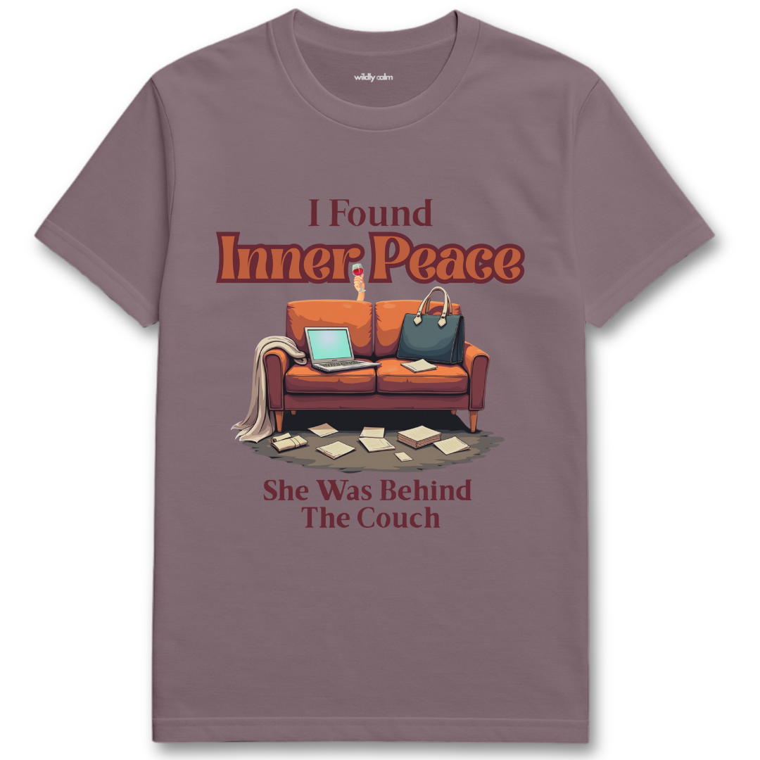 Paragon t-shirt with a graphic of a couch and text 'I Found Inner Peace She Was Behind The Couch' on a white background - Wildly Calm