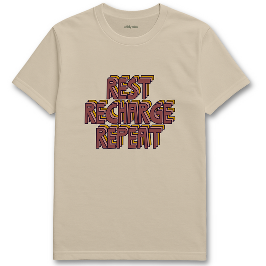 sand/ beige yoga t-shirt with 'REST RECHARGE REPEAT' text in colorful letters - wildly calm